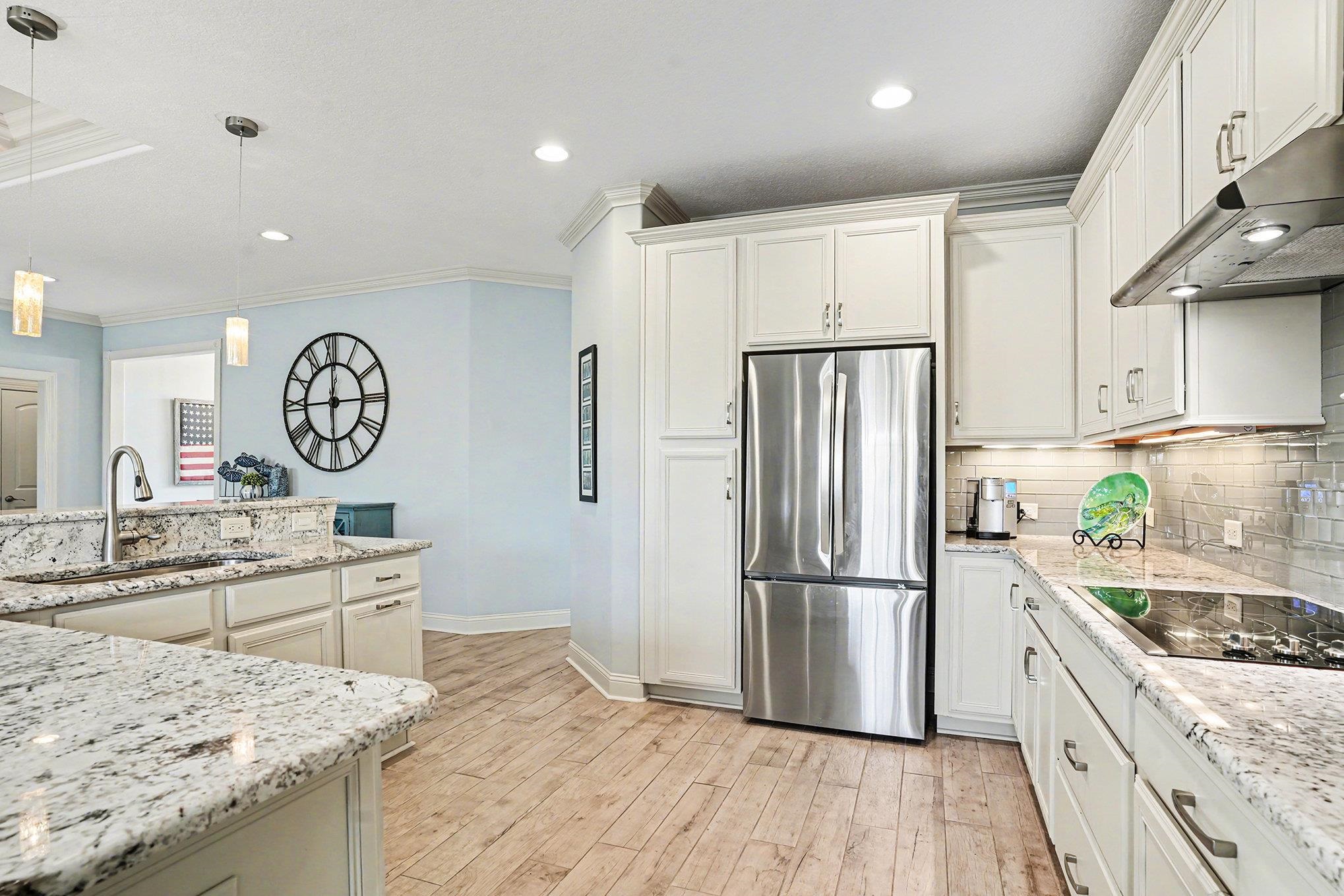 896 Marsala Drive Myrtle Beach, SC 29572 - Photo 12 of 33 Kitchen featuring freestanding refrigerator, crown molding, light stone counters, tasteful backsplash, and recessed lighting