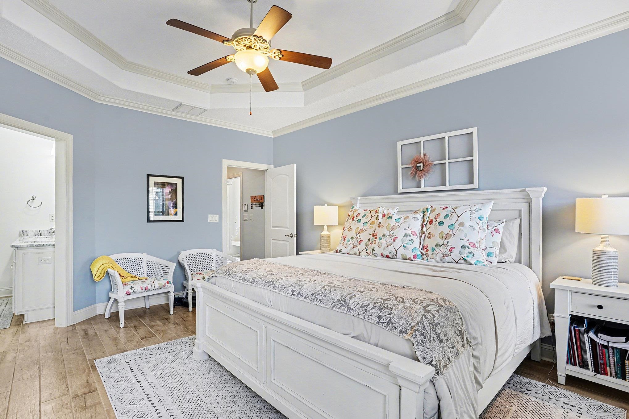 896 Marsala Drive Myrtle Beach, SC 29572 - Photo 16 of 33 Bedroom featuring a tray ceiling, ornamental molding, hardwood / wood-style flooring, ceiling fan, and ensuite bath