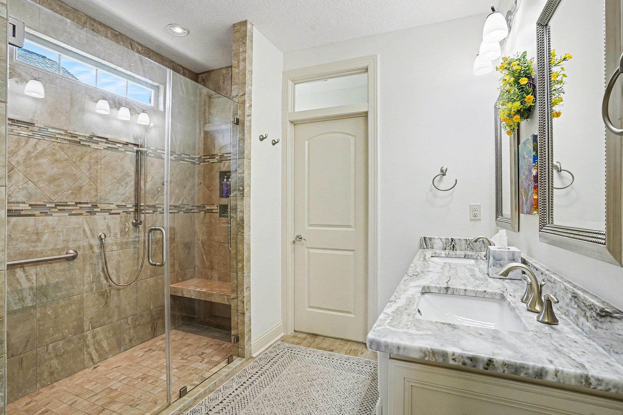 896 Marsala Drive Myrtle Beach, SC 29572 - Photo 18 of 33 Full bath with double vanity, a shower stall, a textured ceiling, and light wood-type flooring