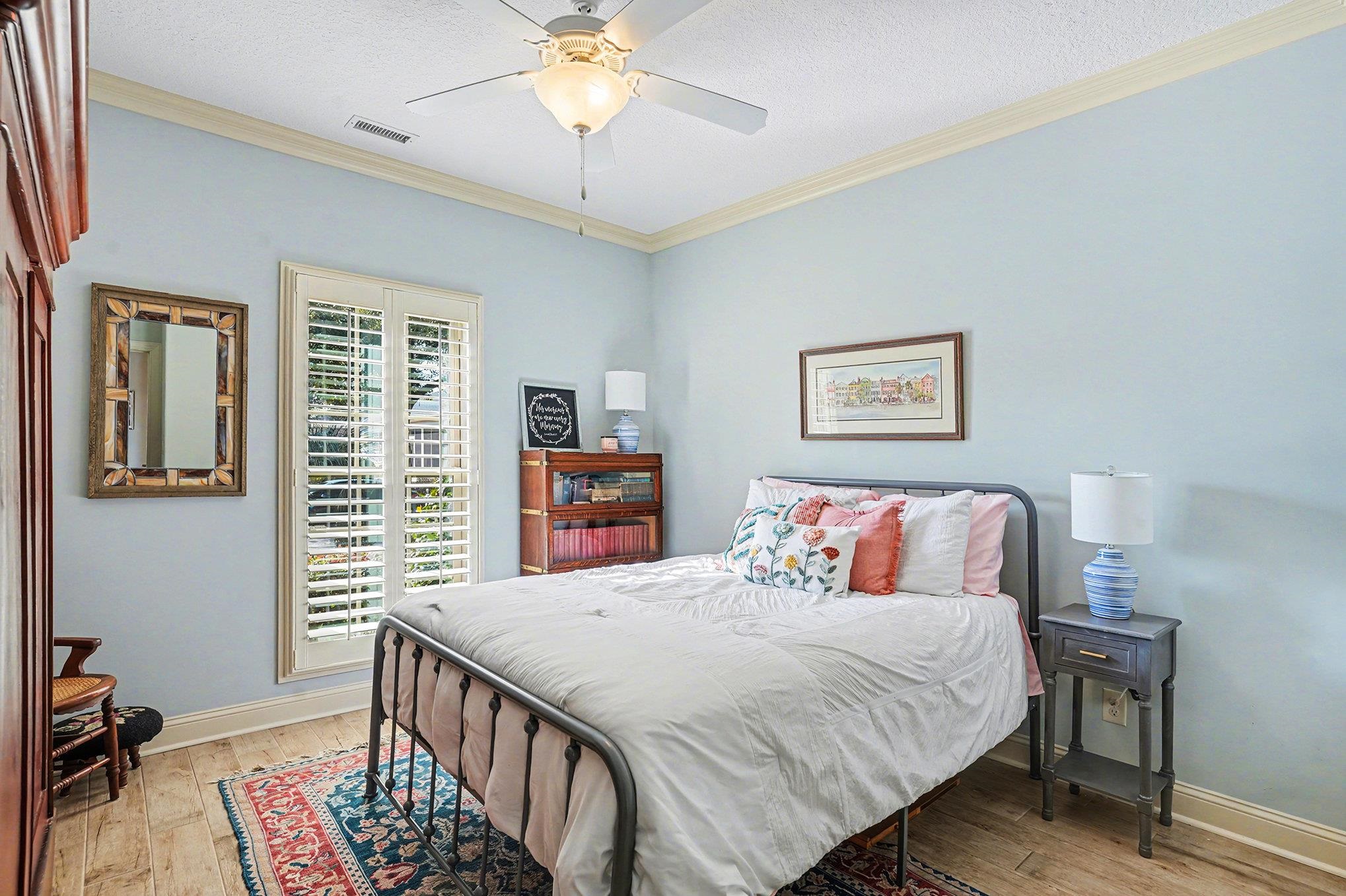 896 Marsala Drive Myrtle Beach, SC 29572 - Photo 19 of 33 Bedroom with crown molding, light wood finished floors, ceiling fan, and a textured ceiling