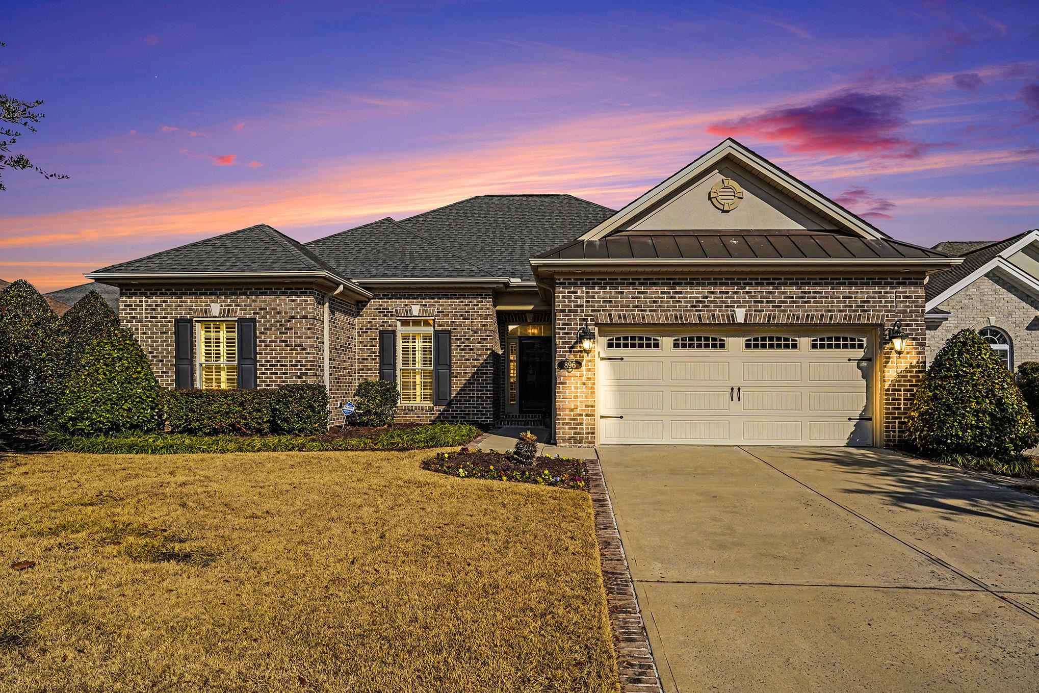 896 Marsala Drive Myrtle Beach, SC 29572 - Photo 3 of 33 View of front of home with brick siding, concrete driveway, a front lawn, and an attached garage