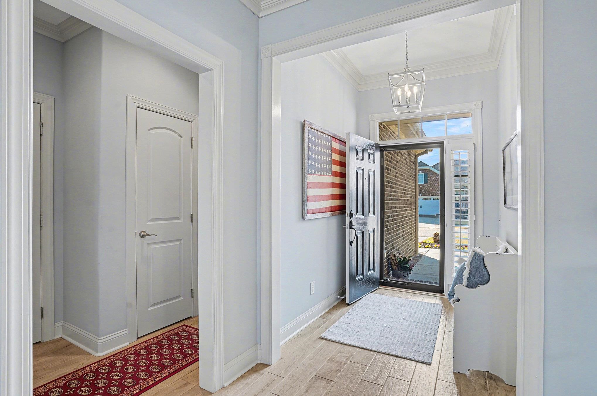 896 Marsala Drive Myrtle Beach, SC 29572 - Photo 4 of 33 Foyer entrance with ornamental molding, wood finish floors, and a chandelier