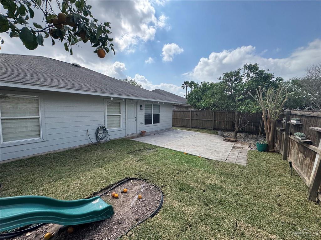 4110 Santa Fabiola Mission, TX 78572 - Photo 11 of 13 a backyard of a house with barbeque oven fire pit table and chairs