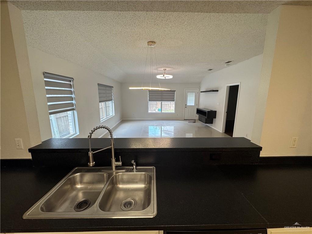 4110 Santa Fabiola Mission, TX 78572 - Photo 2 of 13 a view of a kitchen with kitchen island a sink dishwasher a stove and a refrigerator with wooden floor