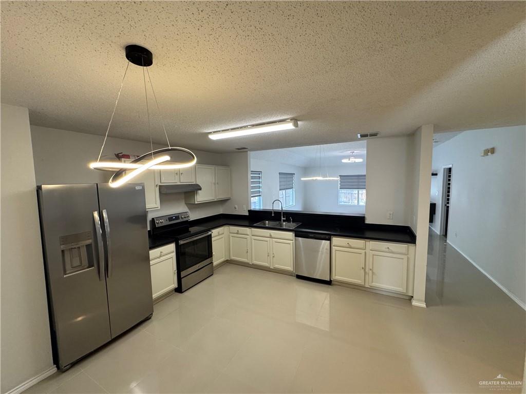 4110 Santa Fabiola Mission, TX 78572 - Photo 3 of 13 a kitchen with stainless steel appliances a refrigerator and a stove