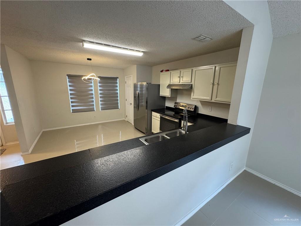 4110 Santa Fabiola Mission, TX 78572 - Photo 4 of 13 a view of a kitchen counter top space a sink a window and appliances