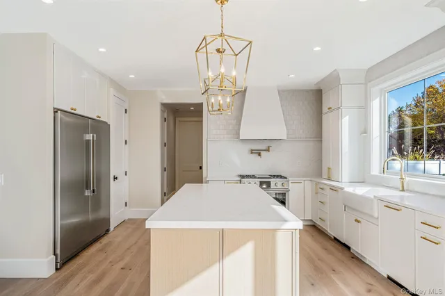 a kitchen with wooden floor and white appliances