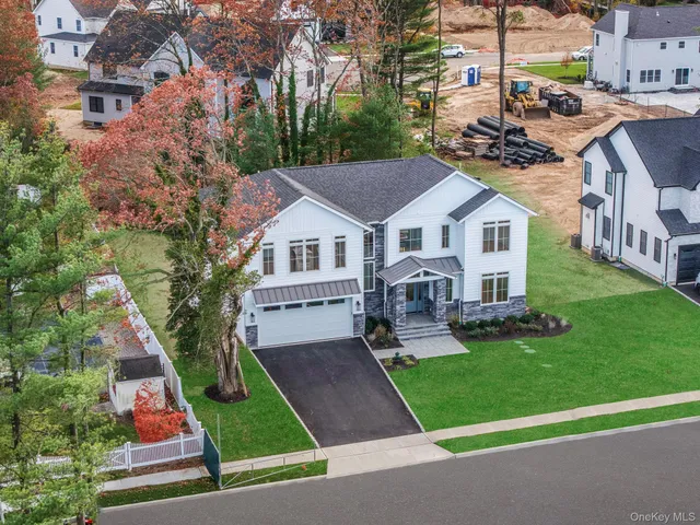 a front view of house with yard and green space