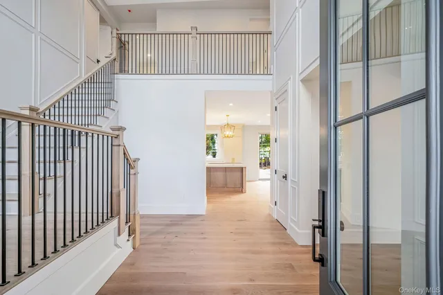 a view of a hallway with wooden floor and entryway