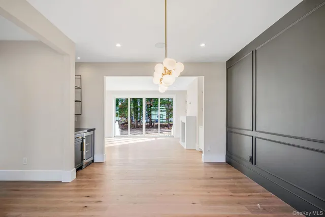 a kitchen with stainless steel appliances granite countertop a refrigerator a sink and a wooden floor