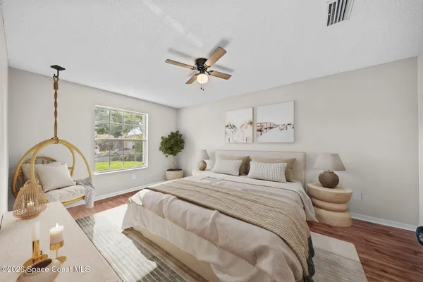 a bedroom with a bed and a large window