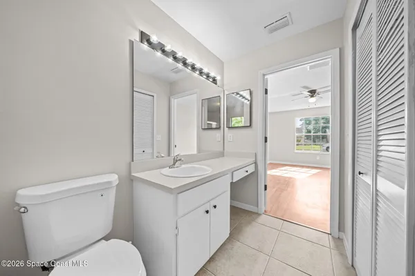 a spacious bathroom with a toilet sink and mirror