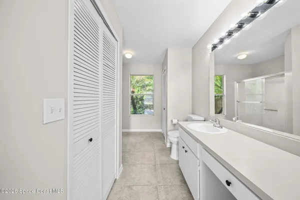 a spacious bathroom with a double vanity sink and a mirror
