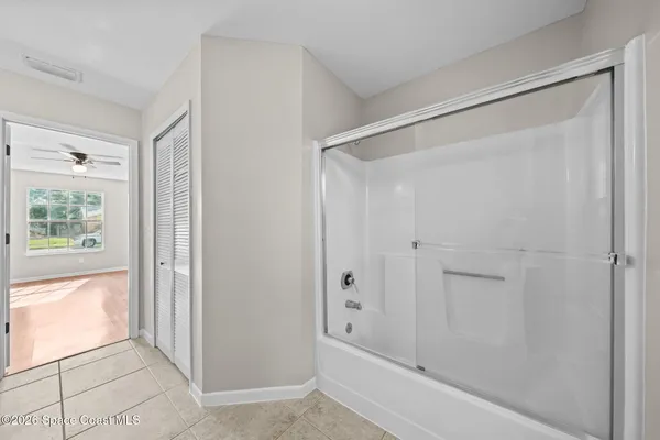 a bathroom with a bathtub and shower