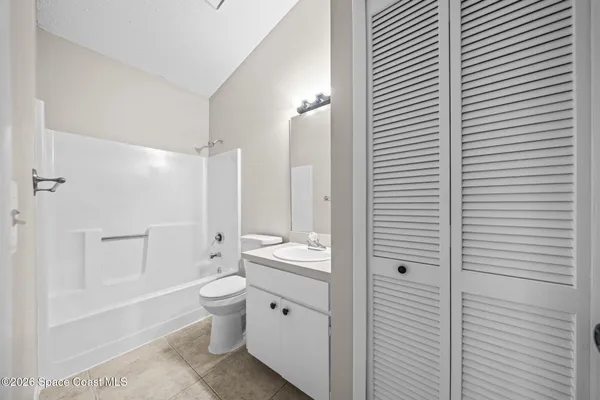 a bathroom with a toilet a sink and shower