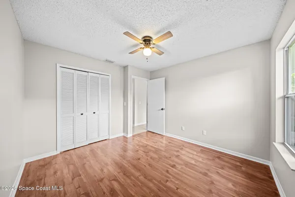 a view of a livingroom with a window and a ceiling fan
