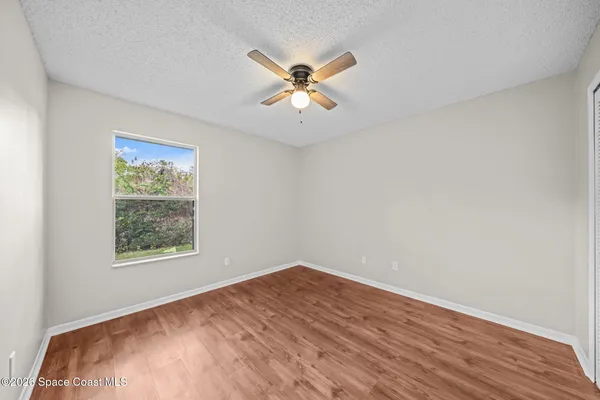a view of a ceiling fan and wooden floor