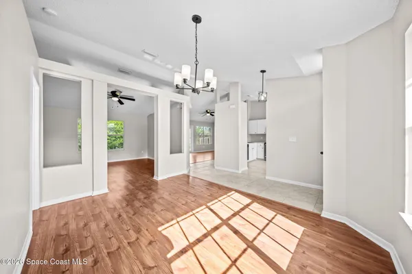 a very nice looking room with a large bed and chandelier