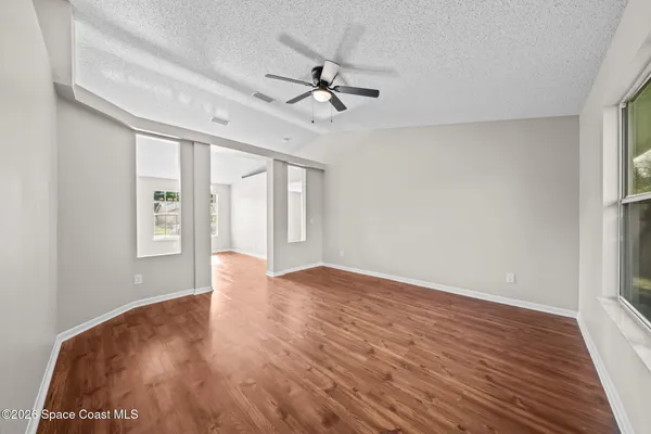 wooden floor in an empty room with a window