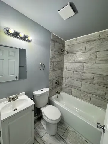 a bathroom with a bathtub and a toilet