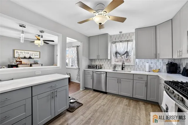 a kitchen with a white cabinets and chandelier