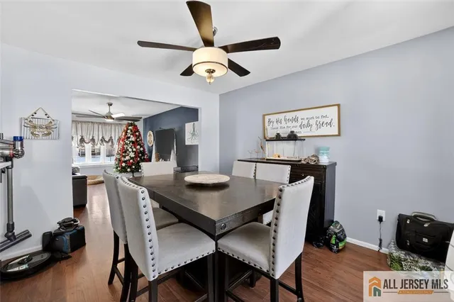 a view of a dining room with furniture and a chandelier