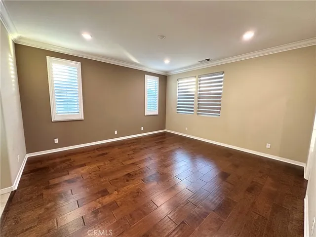 a view of a room with wooden floor