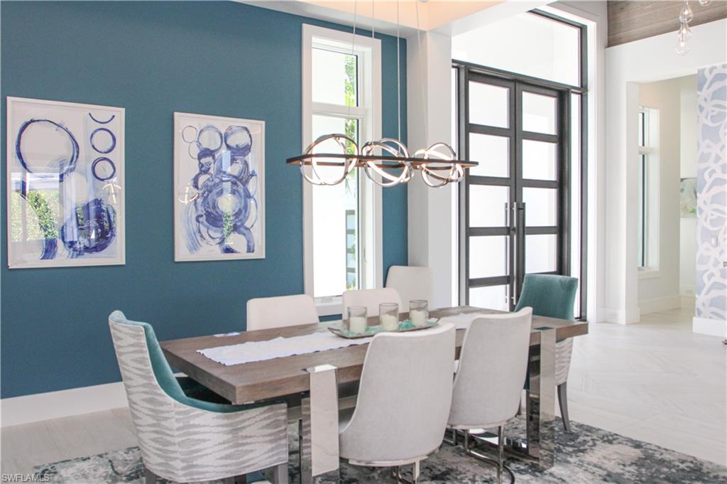 3123 Crayton Road Naples, FL 34103 - Photo 19 of 50 a dining room with furniture a rug and wooden floor