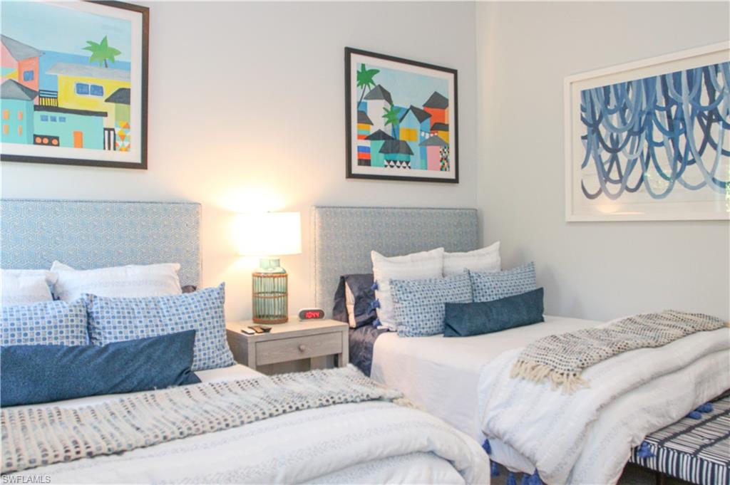 3123 Crayton Road Naples, FL 34103 - Photo 21 of 50 a bedroom with a bed and painting on the wall