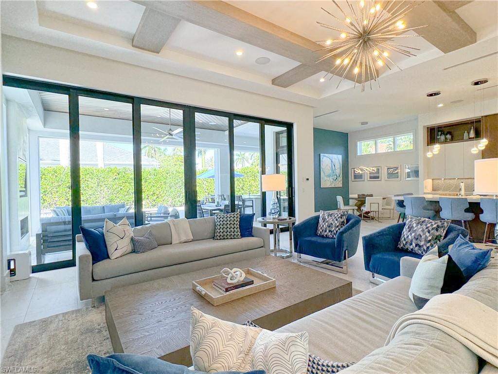 3123 Crayton Road Naples, FL 34103 - Photo 26 of 50 a living room with furniture and a large window