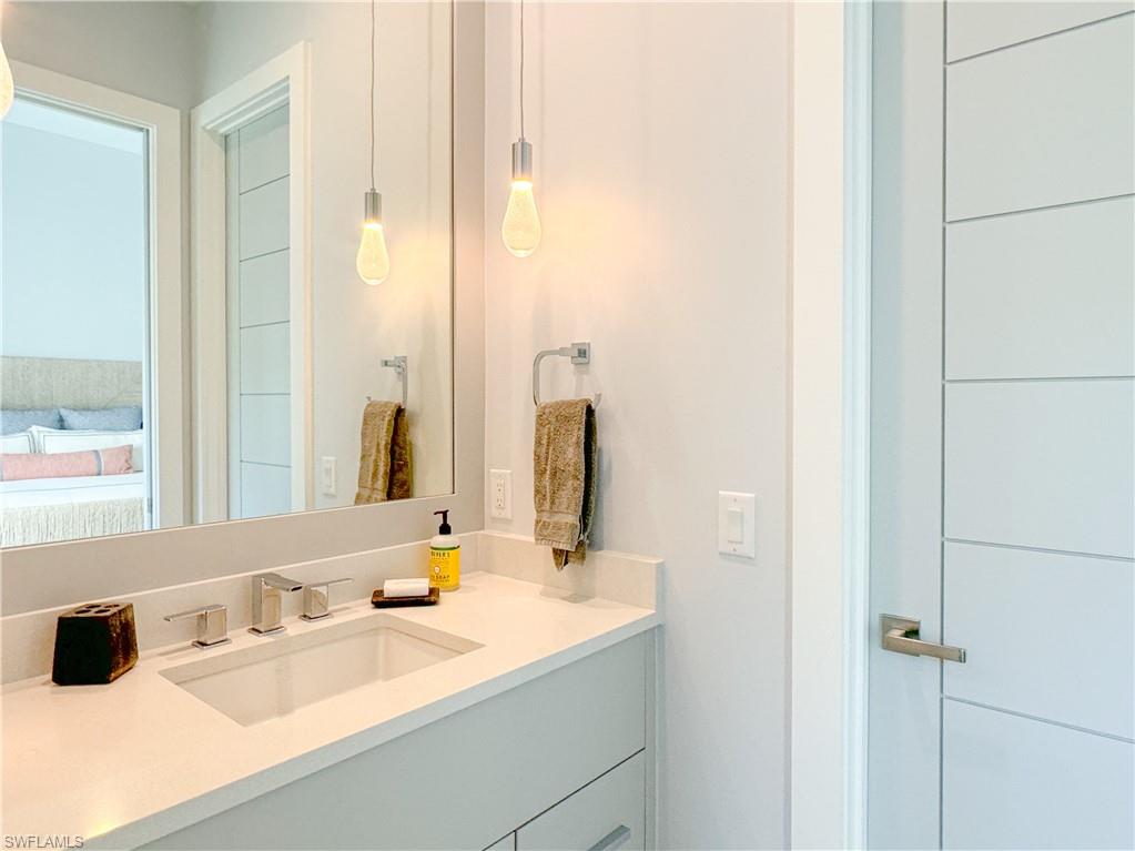 3123 Crayton Road Naples, FL 34103 - Photo 45 of 50 a bathroom with a sink and a mirror