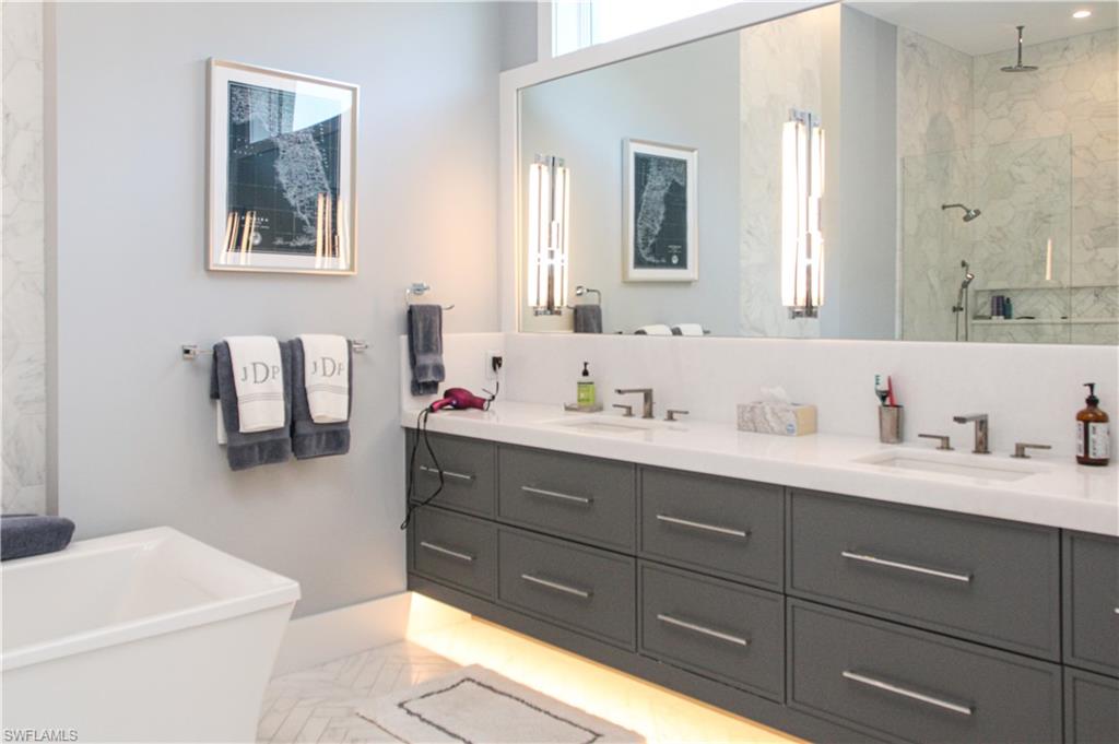 3123 Crayton Road Naples, FL 34103 - Photo 7 of 50 a bathroom with a sink vanity and mirror