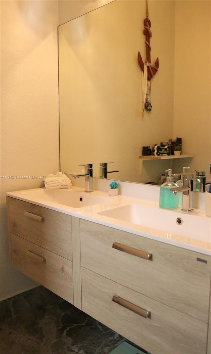 4929 Southwest 140th Terrace, Unit 5 Miramar, FL 33027 - Photo 14 of 24 a bathroom with a sink and a mirror