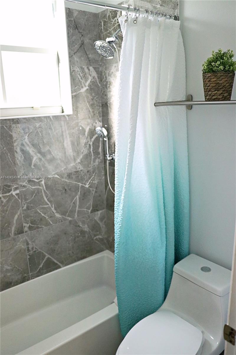 4929 Southwest 140th Terrace, Unit 5 Miramar, FL 33027 - Photo 15 of 24 a bathroom with a toilet and a shower