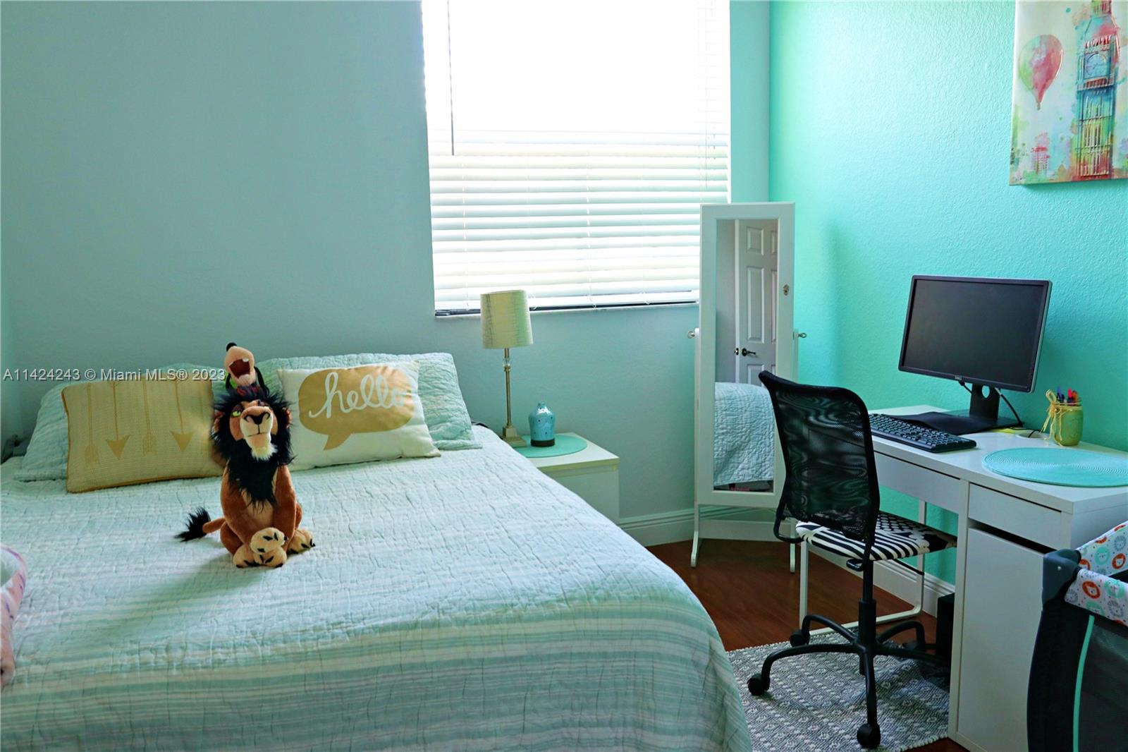 4929 Southwest 140th Terrace, Unit 5 Miramar, FL 33027 - Photo 19 of 24 a bedroom with a bed and a desk