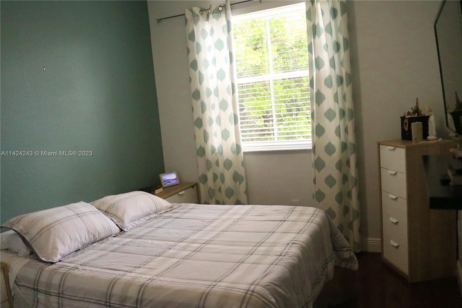 4929 Southwest 140th Terrace, Unit 5 Miramar, FL 33027 - Photo 21 of 24 a bedroom with a bed and a window