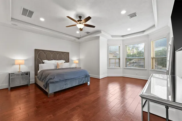 a bedroom with a large bed and a large window