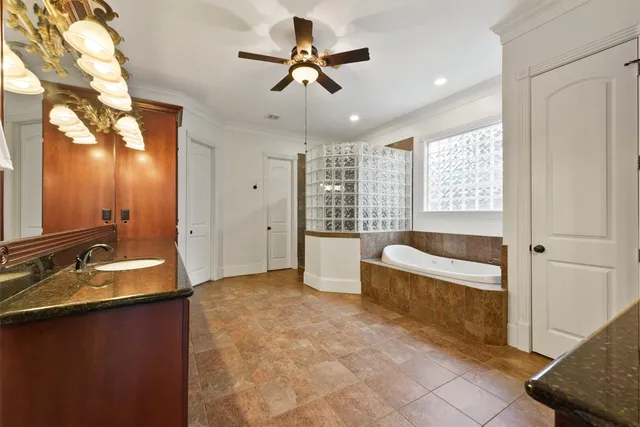 a spacious bathroom with a large tub shower and sink
