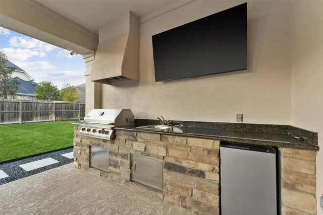 a kitchen with a sink a stove and a microwave