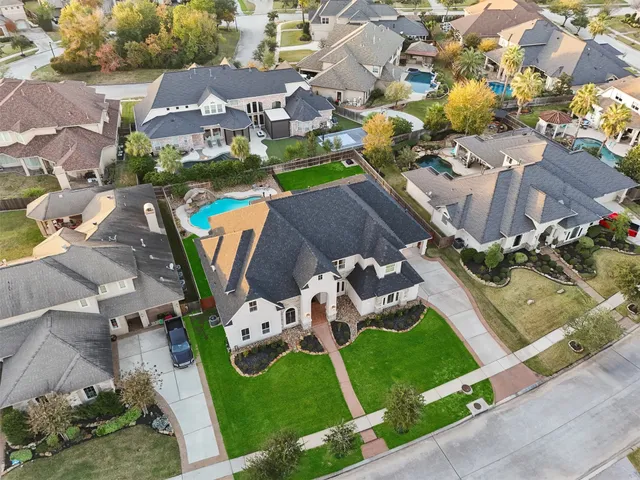 an aerial view of a house with garden space and street view