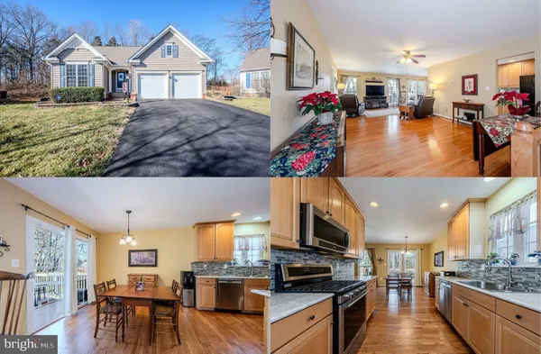a very nice looking open kitchen with stainless steel appliances granite countertop a stove and a view of living room