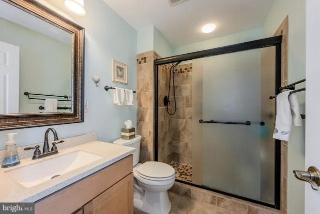 a view of walk in closet with clothes