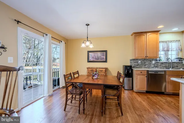 a living room with dining table and chairs