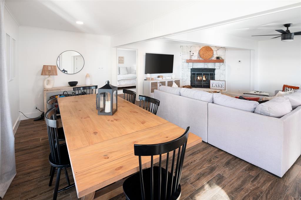 1169 Willow Road Graford, TX 76449 - Photo 13 of 40 a living room with furniture a fireplace and a flat screen tv