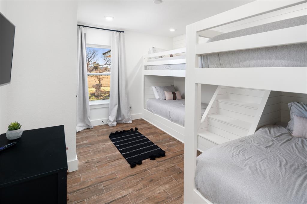 1169 Willow Road Graford, TX 76449 - Photo 24 of 40 a bedroom with a bed and a mirror