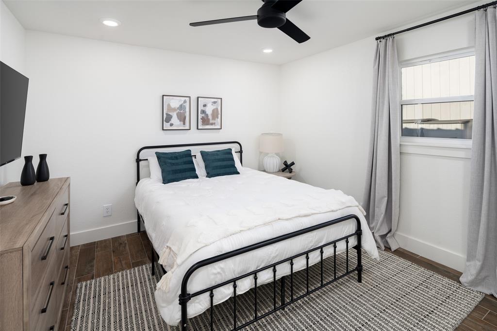 1169 Willow Road Graford, TX 76449 - Photo 27 of 40 a bedroom with a bed and wooden floor