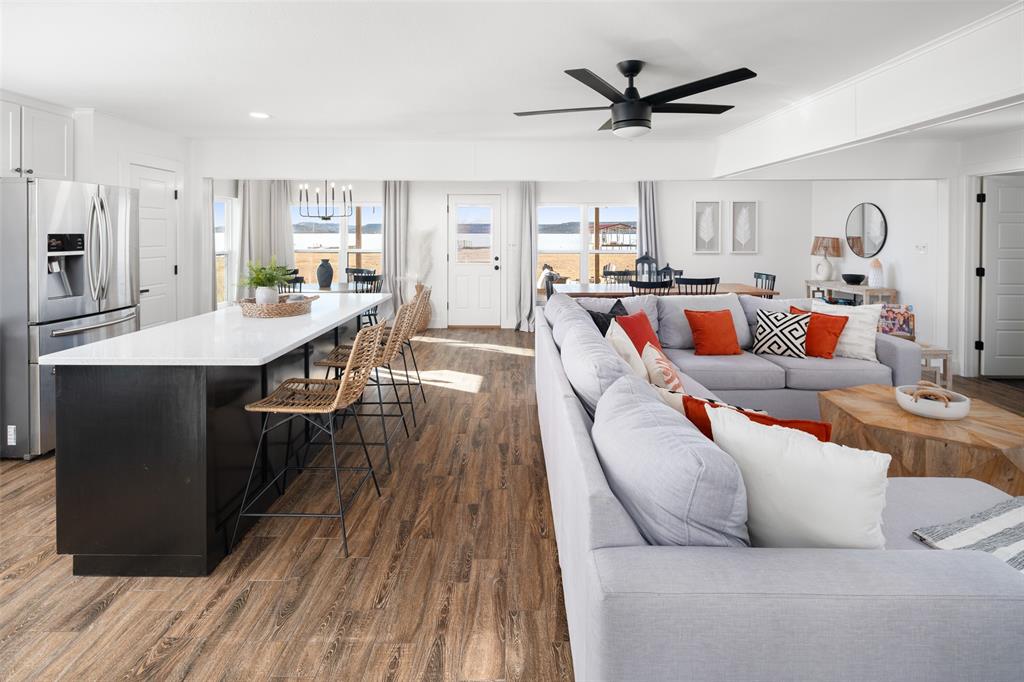 1169 Willow Road Graford, TX 76449 - Photo 6 of 40 a living room with stainless steel appliances kitchen island furniture and a table