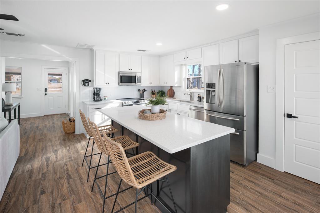 1169 Willow Road Graford, TX 76449 - Photo 8 of 40 a kitchen with a dining table chairs and refrigerator