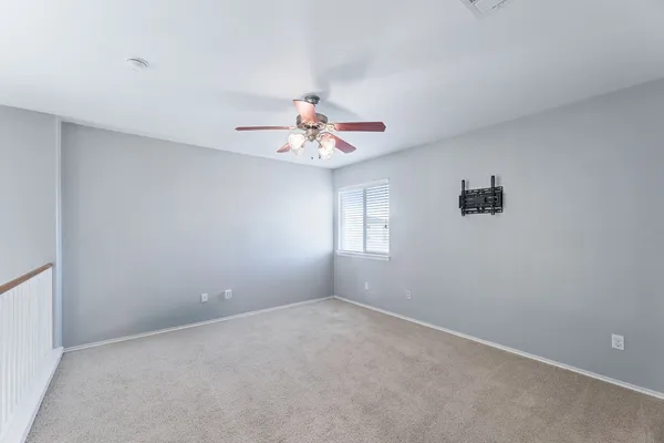a view of a room with window and ceiling fan