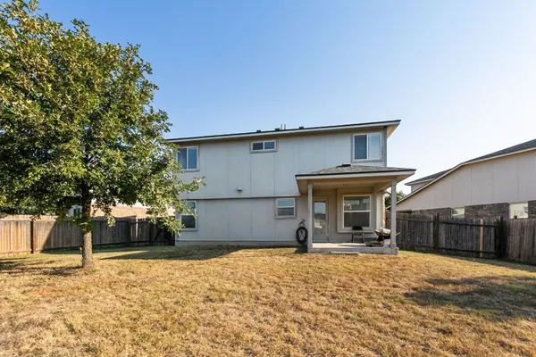a view of a house with snow on the road